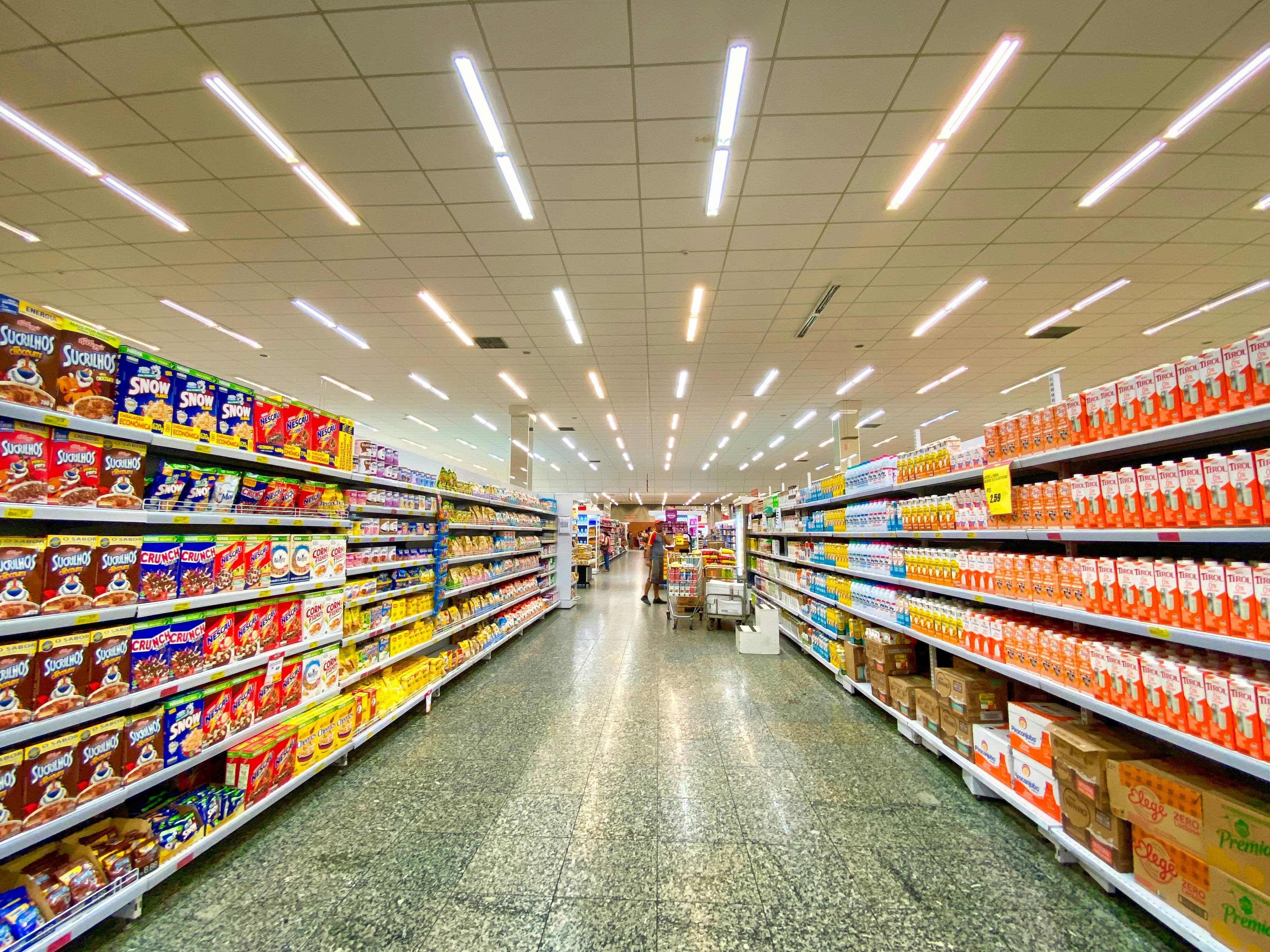 Pasillo iluminado de la tienda Quick! Mini Market con estantes de productos